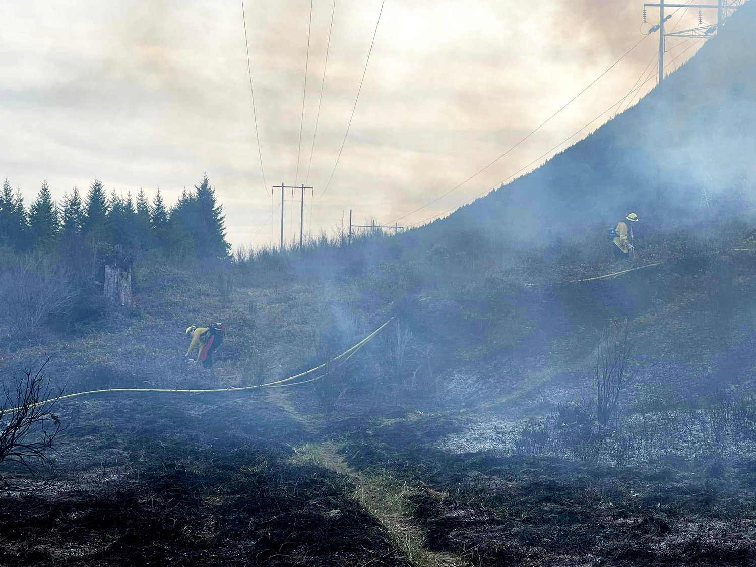 The fire near Spencer Creek Road scorched nearly an acre of state-owned land.
